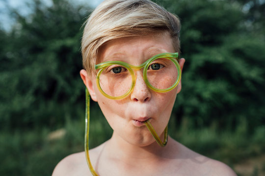 Portrait of freckled boy with funny glasses