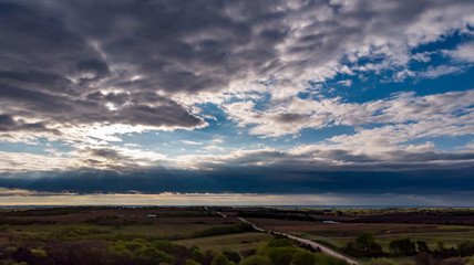 Fototapeta na wymiar Nebraska countryside landscape trees, water, and sky with clouds