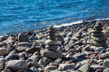 Stones on the coast, pebble pyramids.