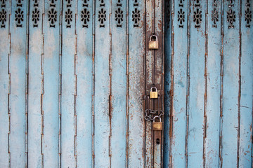 Close Up View of an Old Metal Shop Door with Locks