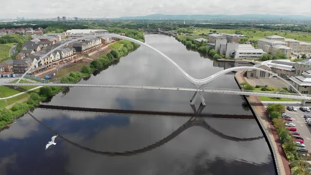The famous Infinity Bridge located in Thornaby Stockton-on-Tees in the UK, showing a typical British landscape taken on a bright sunny part cloudy day.