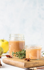 Spicy pear jam in glass jar, fresh pears, spices (cinnamon and anise) and thyme.