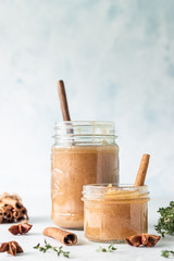 Spicy pear jam in glass jar, fresh pears, spices (cinnamon and anise) and thyme.