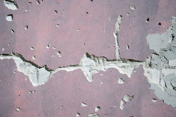 Destruction of plaster on the wall of white brick, red.