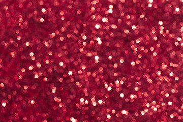 Abstract red background. Shiny glitter bokeh in red colors.