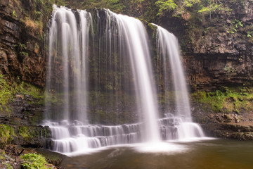 Fototapeta na wymiar Long exposure shot of waterfall, in the Brecon Beacons, Wales scenic waterfall with flowing water