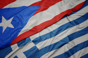 waving colorful flag of greece and national flag of puerto rico.