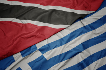 waving colorful flag of greece and national flag of trinidad and tobago.