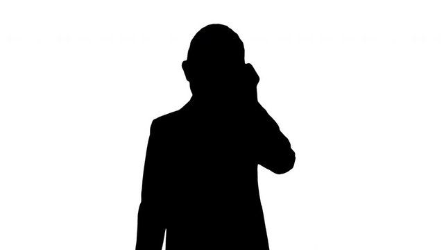 Silhouette Little boy in a costume making a phone call while walking.