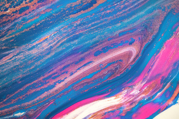 Fototapeta na wymiar Abstract created using the technique of liquid acrylic. Macro photography of the smallest details of a picture. The picture shows how overflows of shades and colors of paint resemble space motifs.