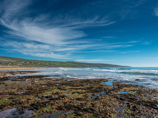 Beautiful Fanore beach county Clare, Ireland, Blue cloudy sky, and ocean water, Stretch of yellow sand.