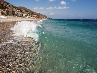 Summer holiday background, Sicily coast, Clear blue wave of the Mediterranean sea, Selective focus.