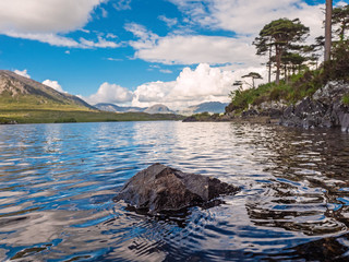 Beautiful landscape view in Connemara National park, Ireland, Pine island, Blue cloudy sky. Mountains in the background.