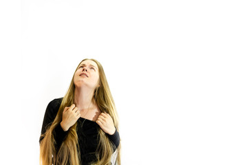 A girl with long blonde hair is in pain, dressed in a black sweatshirt, hands tearing his neck and looking up at the light, on a white background