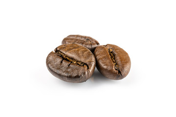 Three shiny fresh roasted coffee beans isolated on white background. Coffee background or texture concept.