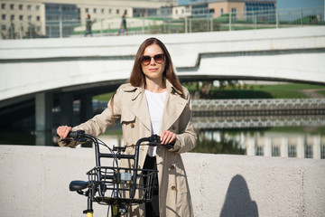 Naklejka premium Happy Hipster Girl with Bike in the City