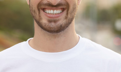 Fototapeta premium Close up portrait of handsome man with beard smiling outside.