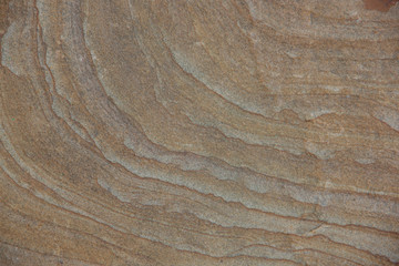 The texture of the stone. Brown stone surface with stripes.