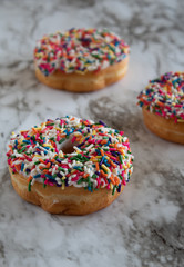 Donuts with white icing and sprinkles