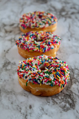 Donuts with white icing and sprinkles