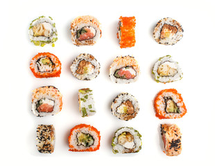 Set of Japanese maki sushi rolls in a rows with salmon, sesame, avocado, cheese and cucumber isolated on white background. Top view. © zgurski1980