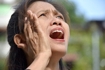 An Older Asian Female Senior Yelling