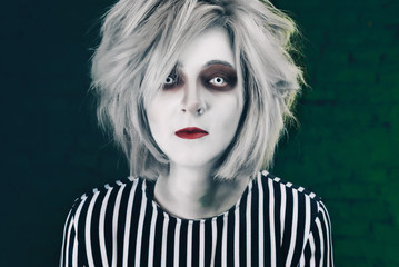 creepy portrait of halloween girl. Creepy eye lenses and make-up for a Halloween party.