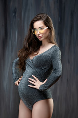 Beautiful slim pregnant woman with glasses. Healthy vision and pregnancy