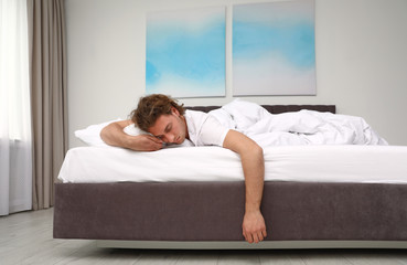 Handsome young man sleeping on pillow at home. Bedtime