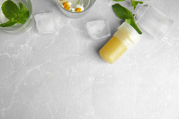 Flat lay composition with natural crystal alum deodorant and space for text on light grey marble...