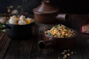 Middle Eastern Couscous and Steamed Vegetables in a Rustic Setting