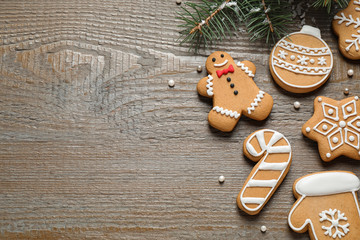 Flat lay composition with tasty homemade Christmas cookies on wooden table, space for text
