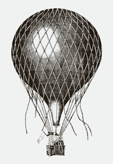 Historical balloon flying with two men on board., after lithography from 19th century © M