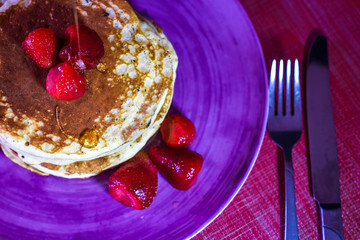 Delicious Hotcakes with strawberry and honey homemade and ready for breakfast.