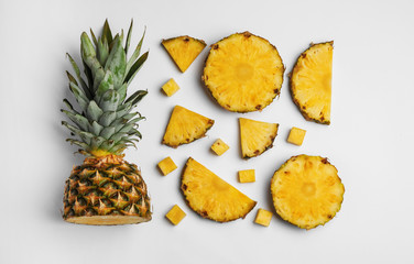 Fototapeta na wymiar Composition with raw cut pineapple on white background, top view
