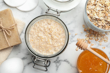 Handmade face mask and ingredients on white marble table, flat lay