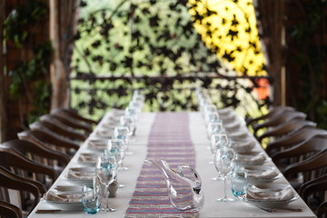 Table set for dining with cutlery, glassware and wine glasses