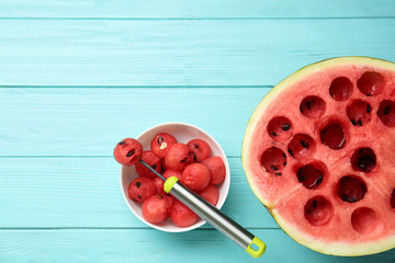 Flat lay composition with watermelon balls on light blue wooden background, space for text