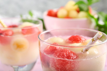 Glasses of melon and watermelon ball cocktail on table, closeup