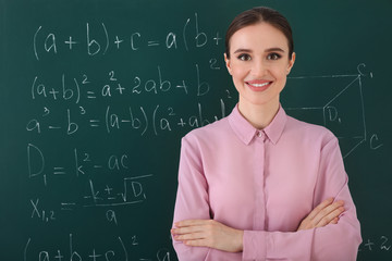 Portrait of young female teacher in classroom
