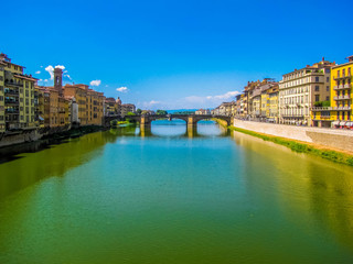 Fototapeta na wymiar View of the Ponte Santa Trinita (Holy Trinity Bridge) and the Arno River. In Florence, Italy