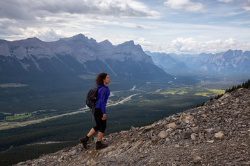 Adventurous Girl is hiking up a rocky mountain during a cloudy and rainy day. Taken from Mt Lady...