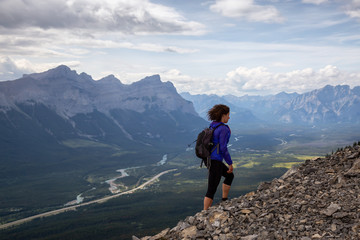 Adventurous Girl is hiking up a rocky mountain during a cloudy and rainy day. Taken from Mt Lady...