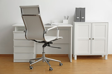 Stylish workplace interior with modern office chair and desk