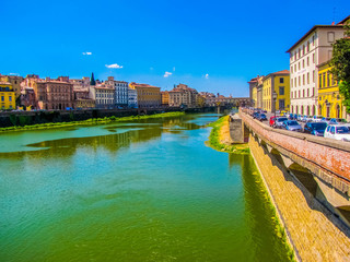 Fototapeta na wymiar View of the Arno River with the Ponte Vecchio (Old Bridge) in the background. In Florence, Italy