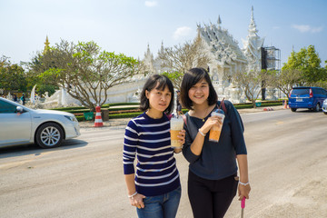 Tourist women travel in temple drinking with ice coffee