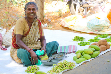 Indian old lady selling the fruits in market