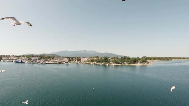 Sailing past the Port of Keramoti, Greece on a sunny summer day.