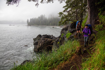 Adventurous friends are hiking Juan de Fuca Trail to Sombrio Beach on the Pacific Ocean Coast...