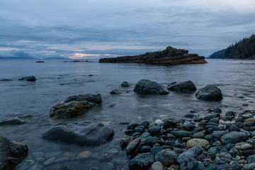 Fototapeta na wymiar Beautiful View of a rocky beach on the Juan de Fuca Trail during a summer sunset. Taken at Chin Beach, near Port Renfrew, Vancouver Island, BC, Canada.